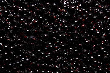 Black pearls close-up. water drops on a surface. wine bubbles. beads. beads on black. drops of...