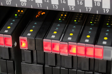 Lighting status indicator signals on electric control panel of automatic SMD pick and place machine at factory. Automated technology, industrial, electronic, production and manufacturing concept