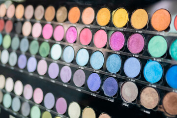 Close up view of colorful eyeshadow pallet for make up in cosmetic store. Makeup, beauty, fashion, glamour concept