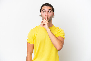 Caucasian handsome man isolated on white background showing a sign of silence gesture putting...