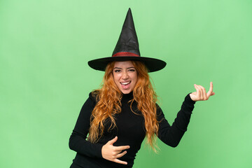 Young caucasian woman costume as witch isolated on green screen chroma key background making guitar gesture - Powered by Adobe