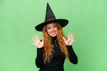 Young caucasian woman costume as witch isolated on green screen chroma key background counting nine with fingers