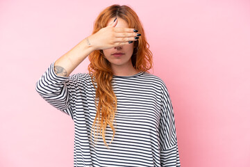 Young caucasian woman isolated on pink background covering eyes by hands. Do not want to see something