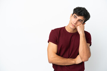 Young Argentinian man isolated on white background with tired and bored expression