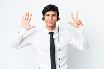 Telemarketer man working with a headset isolated on white background counting eight with fingers