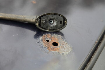 Car roof corrosion under antenna with removed aerial