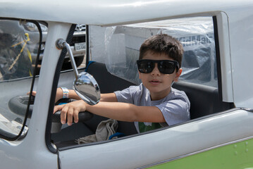 Boy in sunglasses posing in a van of the Scooby Doo mystery machine
