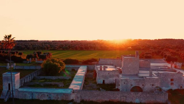 Antica Masseria Maviglia (La Maija)  al tramonto tra gli alberi d'ulivo in primavera - vista aerea dal drone - Maruggio, Taranto, Puglia, Salento, Italy