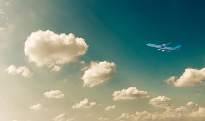 Fototapeta na wymiar Commercial airplane flying against blue dramatic cloudscape sky. Jet plane in high flight. Airliner flying under the clouds. Aircraft flying in the clouds. 