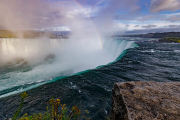 rainbow over waterfall