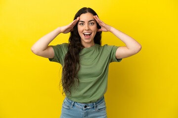 Young caucasian woman isolated on yellow background with surprise expression