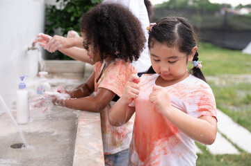 Funny kid girls washing hand and rubbing with soap