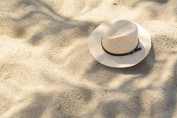 Fototapeta na wymiar Stylish straw hat on sand outdoors, space for text