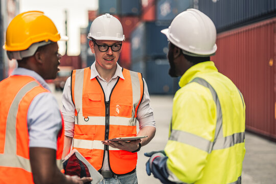 Container operator is discussing their daily routine task before the start of their day in the container yard.