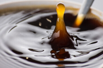 a drop falls into a mug of coffee macro