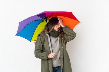 Young caucasian woman holding an umbrella isolated on white background has realized something and intending the solution