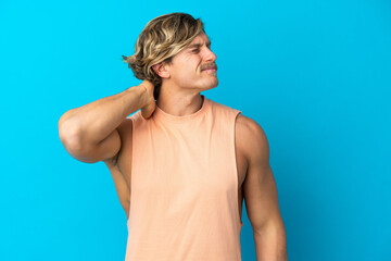 Handsome blonde man isolated on blue background with neckache