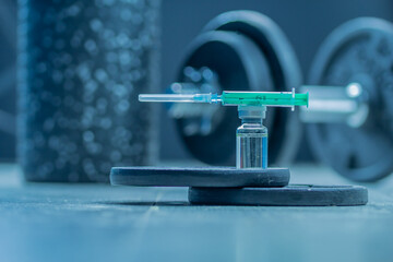 dumbbells, syringe with needle, pills and vial with steroids. illegal doping in sport concept - obrazy, fototapety, plakaty