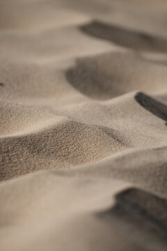 Close Up On The Sand Of A Beach. Creates The Impression Of A Desert Dune Aerial View. Tilt Shift Effect