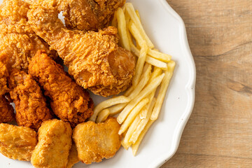 fried chicken with french fries and nuggets on plate