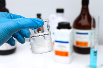 Ammonium carbonate in glass, chemical in the laboratory and industry