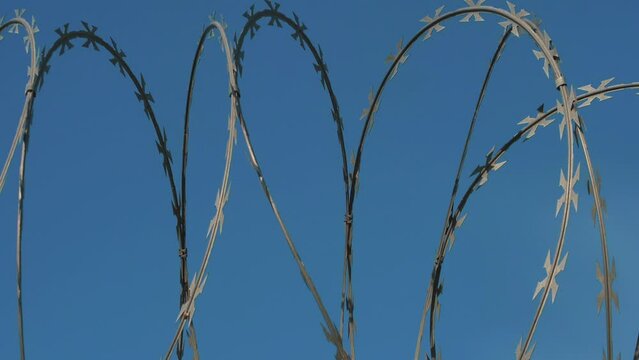 Barbed wire fencing. Border wall between countries. Barbed wire fencing around a prison. Conflict between countries.