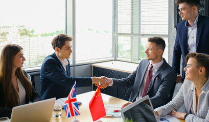 Diversity people talk the international conference partnership. Chinese flag and United Kingdom flag.