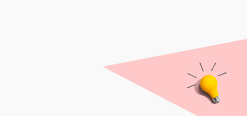 Yellow light bulb - flat lay from above