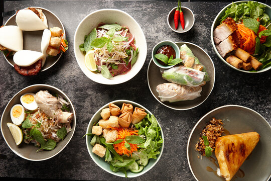 Various Asian food dishes on table