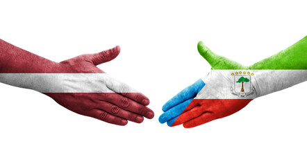 Handshake between Equatorial Guinea and Latvia flags painted on hands, isolated transparent image.