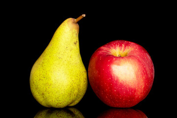 One juicy green pear and red apple, macro, isolated on black background.