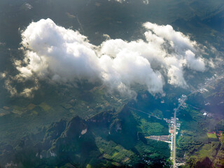 Fototapeta premium Aerial view of tranquil cloudscape in the blue sky with landscape ground below, nature wallpaper.