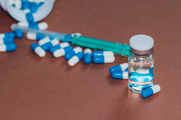 syringe with needle, vial and pills with steroids. illegal doping in sport concept