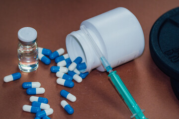 syringe with needle, vial and pills with steroids. illegal doping in sport concept