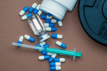 dumbbells, syringe with needle and vial with steroids. illegal doping in sport concept - obrazy, fototapety, plakaty