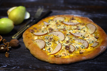 Homemade pizza with pear and walnuts. Dorblu pizza.
