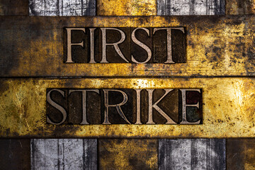 First Strike text on grunge textured copper and gold background