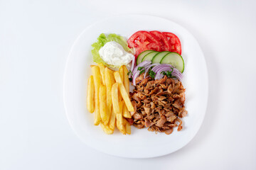 Doner salad plate, kebab chicken meat on white plate. Turkish food. Isolated on white background....