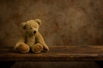 Adorable teddy bear on wooden shelf