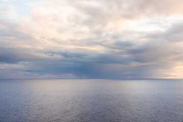 Fototapeta premium Sunrise on the sea background. Beautiful sunrise at the calm sea in light blue color