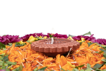 Flower Rangoli for Diwali Festival made using Marigold or Zendu flowers and Clay Oil Lamp