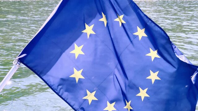 EU European union flag close-up on the boat over river water