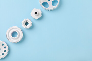 White gears wheels flat lay symbolizing idea, cooperation or teamwork, work and connection concept