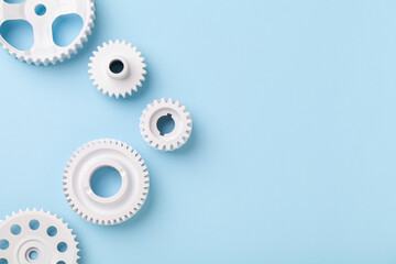 White gears wheels flat lay symbolizing idea, cooperation or teamwork, work and connection concept