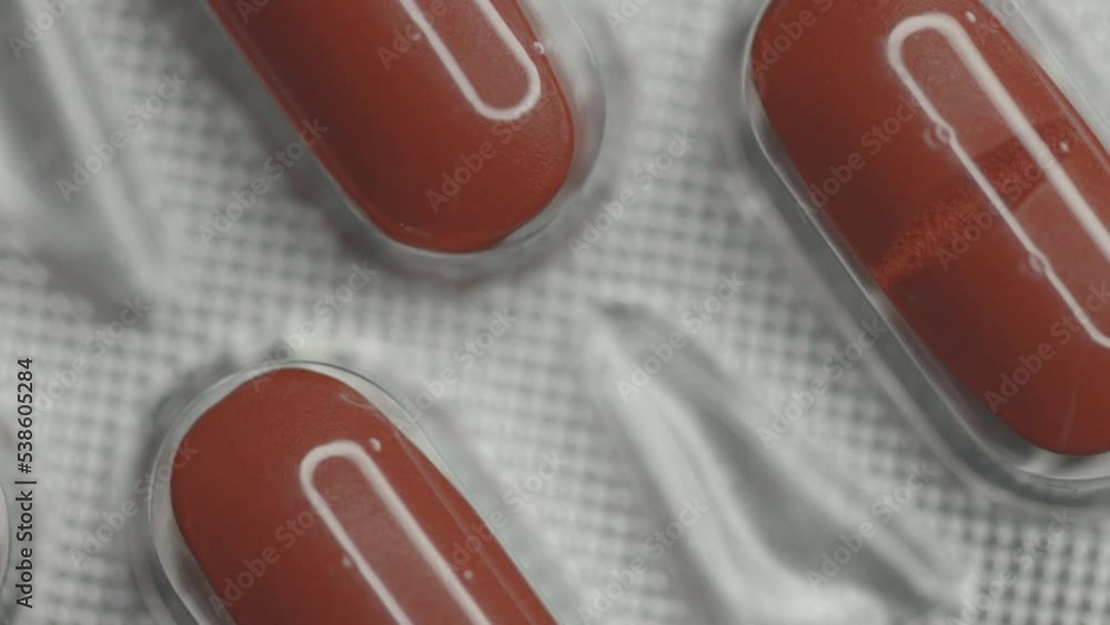 Poster red capsules in a blister are rotated in a circle