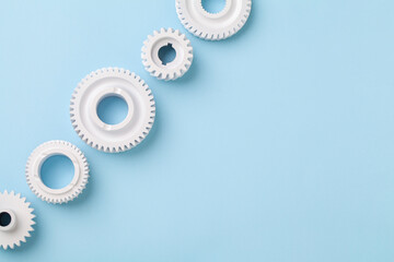 White gears wheels flat lay symbolizing idea, cooperation or teamwork, work and connection concept