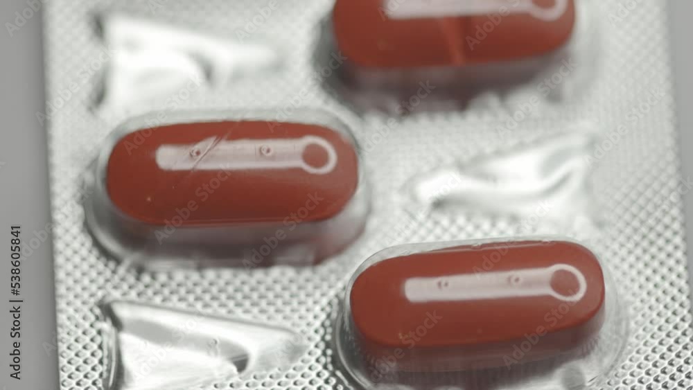 Poster red capsules in a blister are rotated in a circle