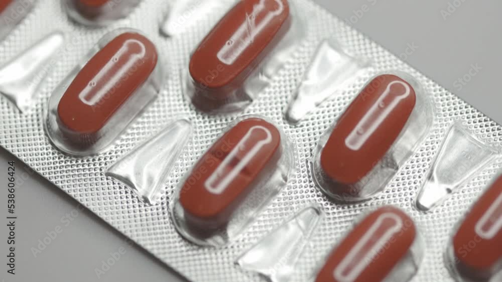 Poster red capsules in a blister are rotated in a circle