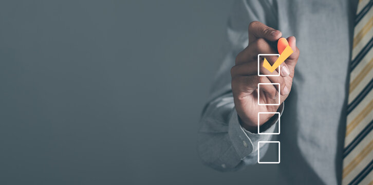 Checklist concept. Businessman checking mark on checkboxes, copy space.
