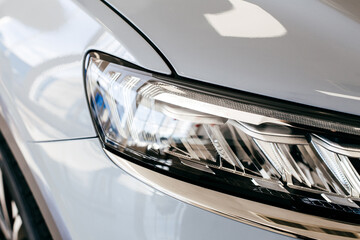 Grey car headlight close up, beautiful car design